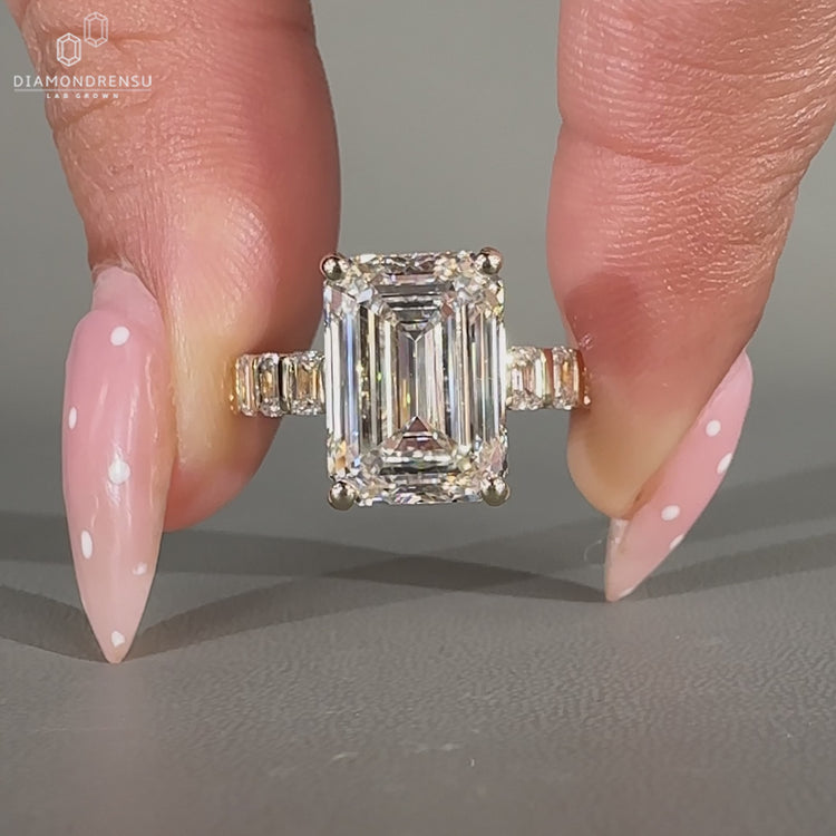 Emerald Cut Engagement Ring with emerald side stones.
