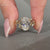 Oval diamond ring nature cluster twisted shank style.
