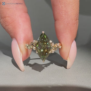 Green diamond ring with round side stones.
