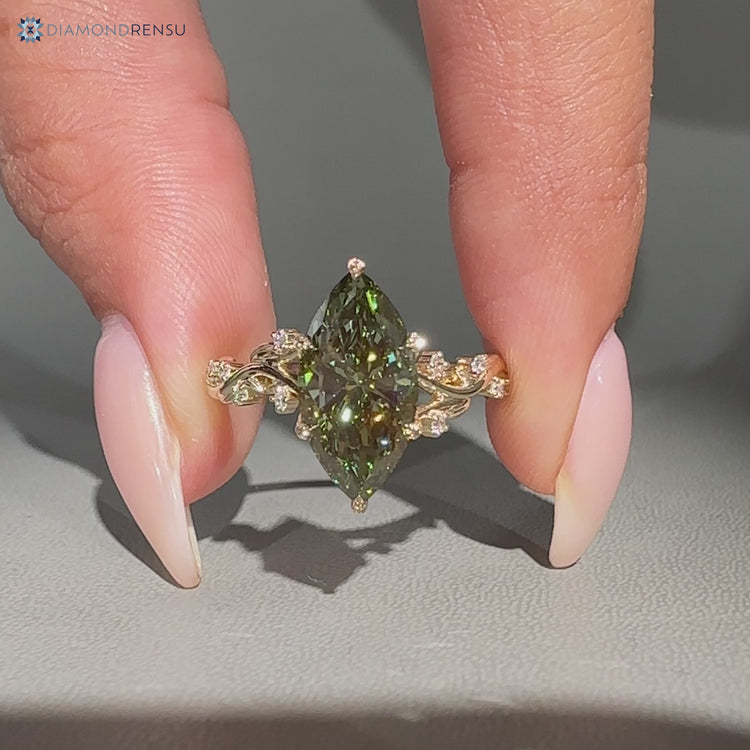 Green diamond ring with round side stones.
