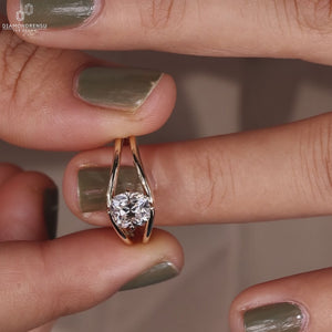 Solitaire engagement ring made with compass prong setting.
