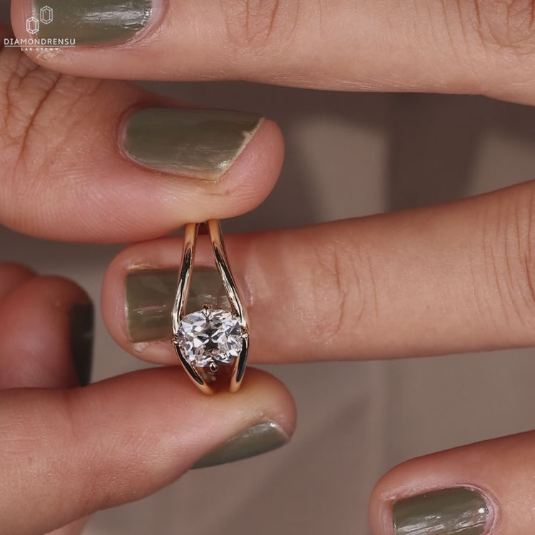 Solitaire engagement ring made with compass prong setting.
