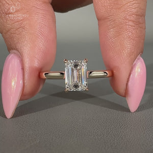Emerald cut diamond ring with 4 claw prong setting.
