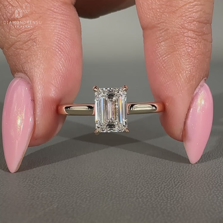 Emerald cut diamond ring with 4 claw prong setting.
