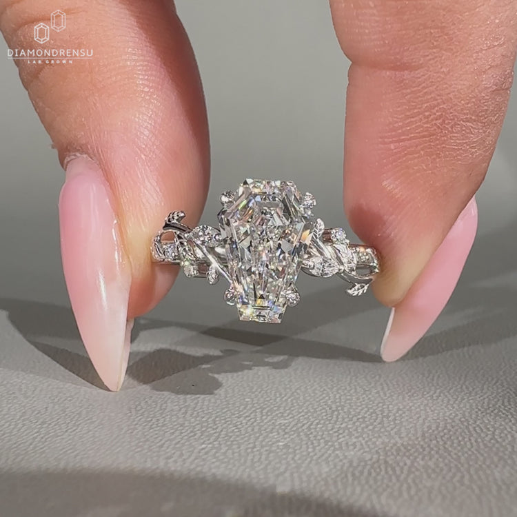 Coffin shaped diamond ring with Marquise & Round side stones.