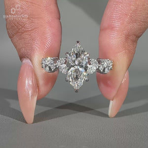 Round side stone ring with marquise centre diamond and zig zag pavé.
