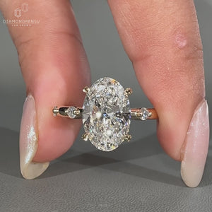 Gold Oval Engagement Ring featuring a leaf style prong setting.
