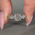 Cushion diamond ring twisted pave cluster style.