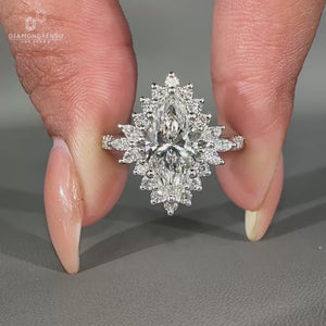 Marquise diamond ring with pavé setting and halo in white gold.
