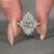 Marquise diamond ring with pavé setting and halo in white gold.
