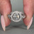 Halo diamond engagement ring in white gold bezel setting.
