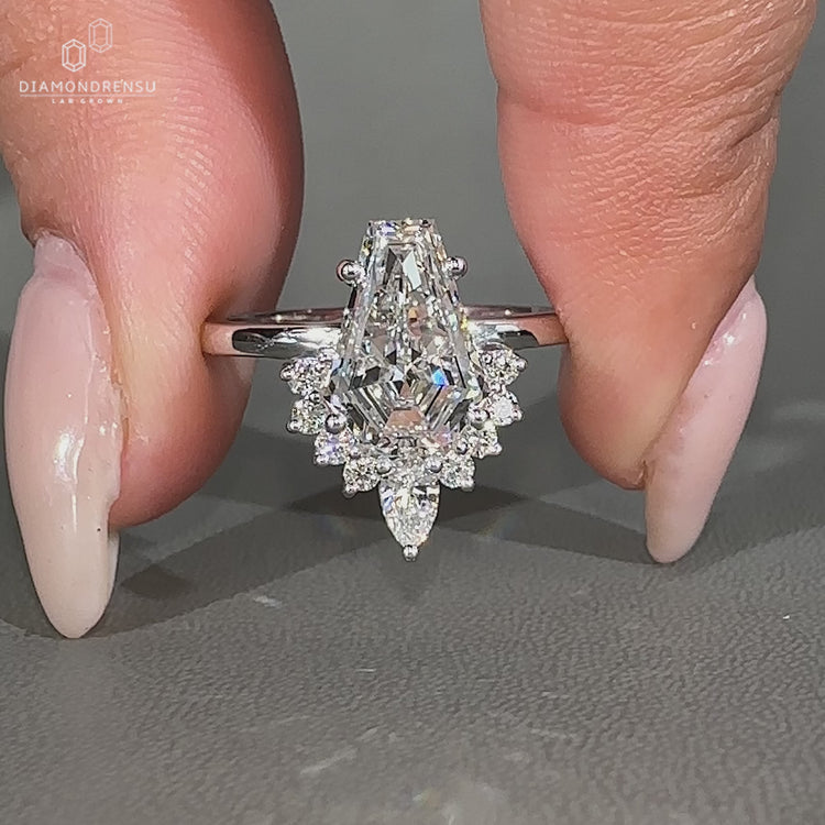 Coffin diamond ring four prong halo setting.