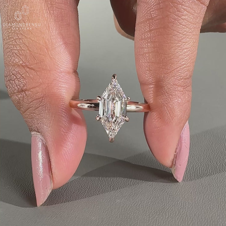 hexagon step cut diamond ring in solitaire setting.
