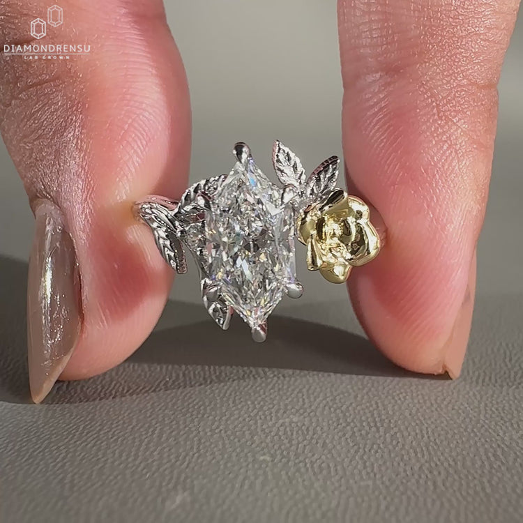 Dutch marquise diamond ring with round side stones and split shank design.
