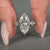 Three stone diamond ring featuring marquise centre stone.