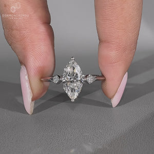 Marquise ring three stone compass prong knife edge.
