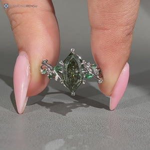Green diamond Dutch marquise ring with emerald side stones.