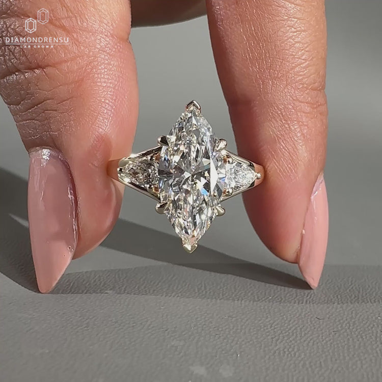 Marquise engagement ring with pear side stone.
