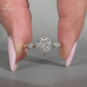 Cushion diamond ring three stone marquise side stones set.
