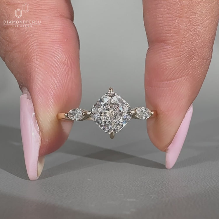 Cushion diamond ring three stone marquise side stones set.
