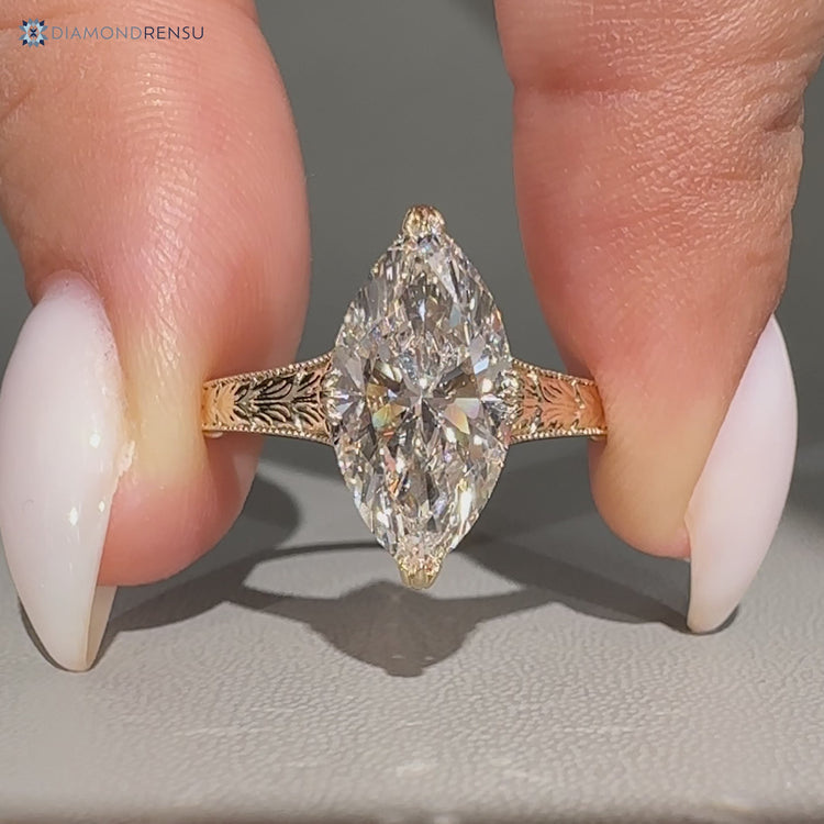 Marquise diamond ring with fishtail prong setting.