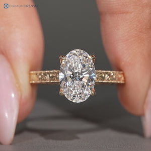 Oval diamond ring with milgrain detailing.