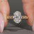 Oval diamond ring with milgrain detailing.