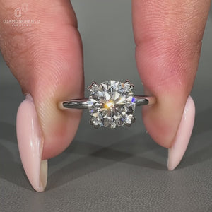 Diamond solitaire engagement ring with double claw prong setting.
