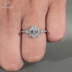 Handmade oval cut diamond ring in a cathedral pave design.
