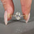 Oval diamond ring round side stones tapered shank set.
