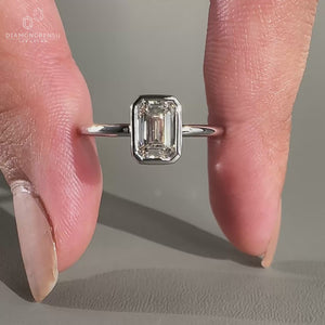Emerald cut diamond ring in white gold ring setting.
