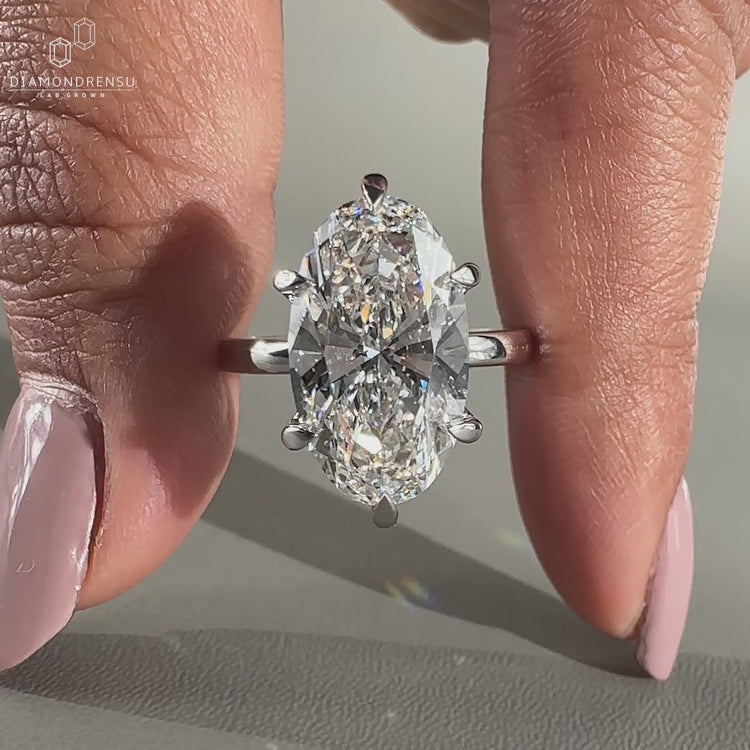 Moval diamond engagement ring in 6 claw prong setting.

