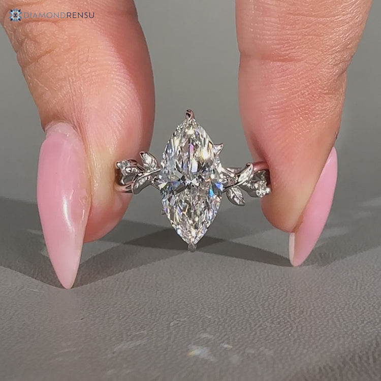 Marquise diamond ring round diamond hidden halo.