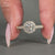 Lab grown round cut diamond ring in halo design.

