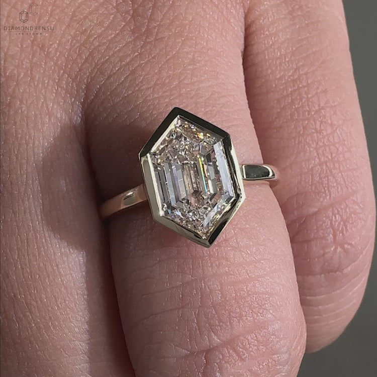 Solitaire engagement ring made in bezel engagement ring style.
