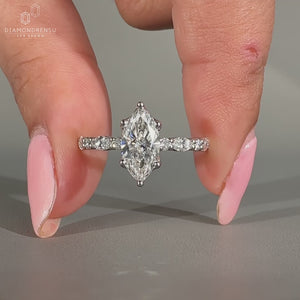 Marquise diamond ring with pave setting.
