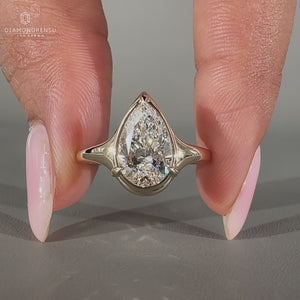Pear diamond ring three claw prong bezel style set.
