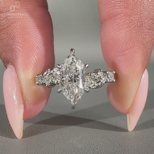 Dutch marquise engagement ring with round side stones and claw prong setting.
