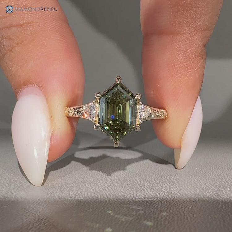 Hexagon diamond ring with three stone setting.