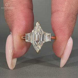 Trapezoid step cut side stone and v prong setting used.

