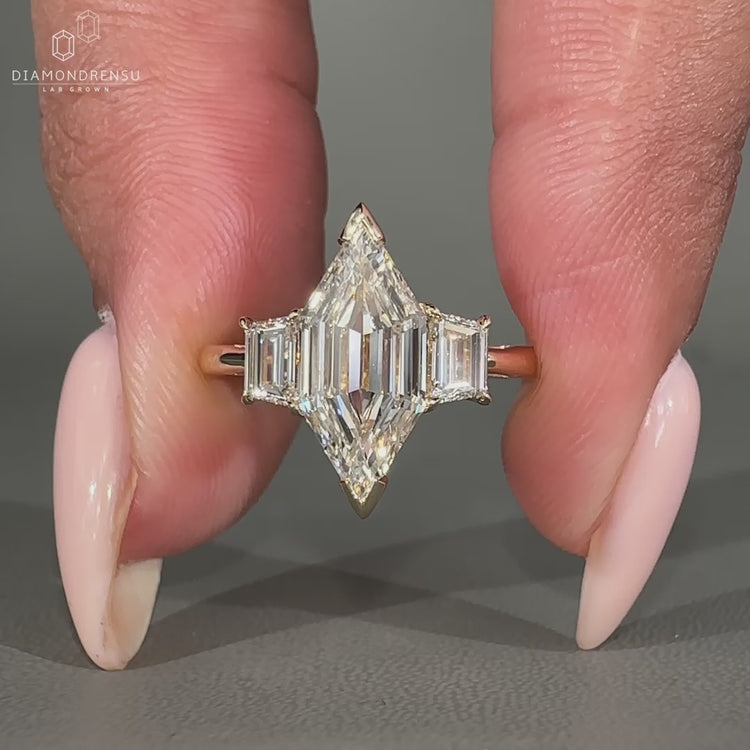 Trapezoid step cut side stone and v prong setting used.
