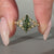 Marquise diamond ring green emerald side gemstone.