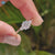 Round moissanite engagement ring three stone style.