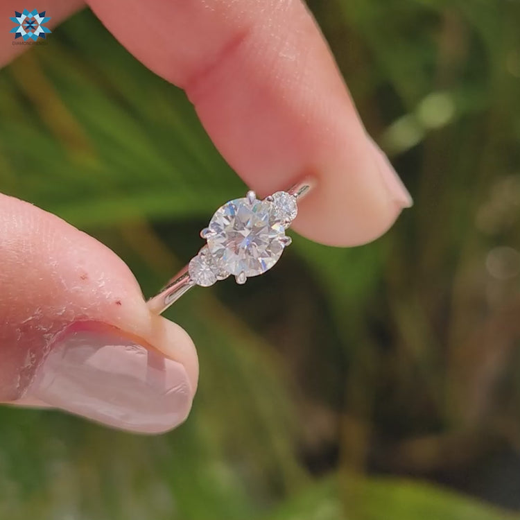 Round moissanite engagement ring three stone style.