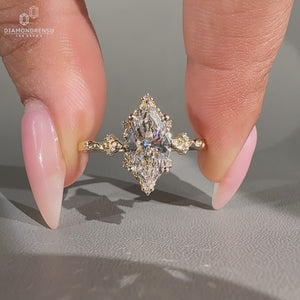Marquise diamond ring round side stones prong set.