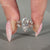 Marquise ring round side stones cluster prong set.