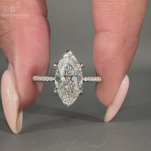 Marquise old mine cut ring featuring a round pave setting and vintage style.
