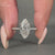 Marquise old mine cut ring featuring a round pave setting and vintage style.
