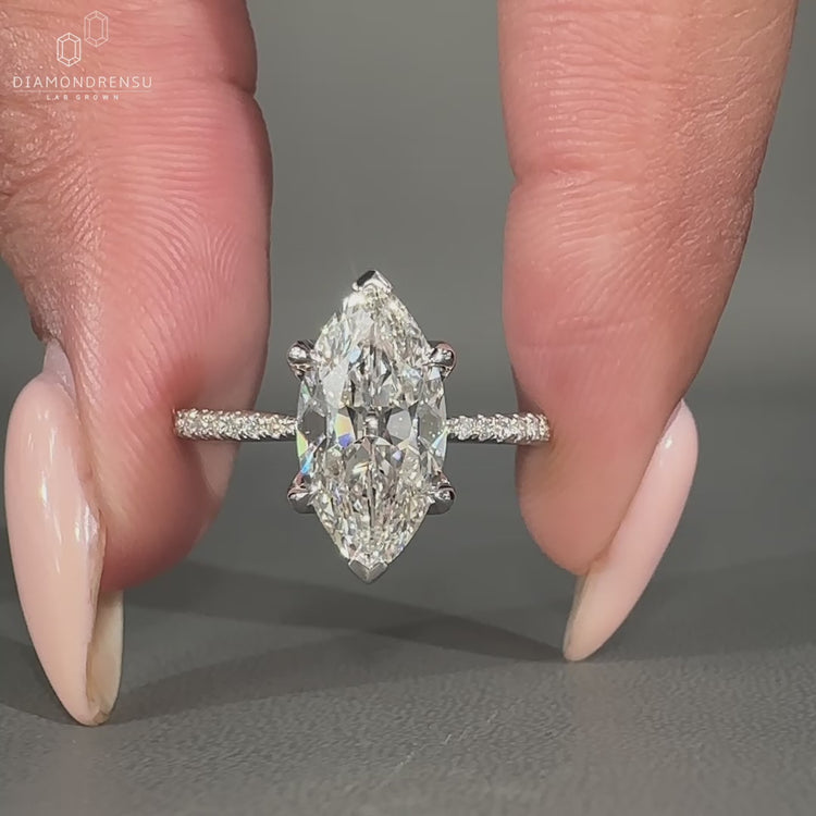 Marquise old mine cut ring featuring a round pave setting and vintage style.
