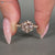 Pink diamond round ring with pave style.